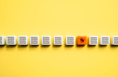 Close-up of toy blocks against yellow background