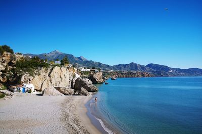Panoramic shot of spanish beach against clear blue sky