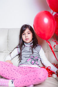 Portrait of cute girl sitting at home