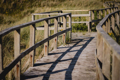 Shadow of railing on grass