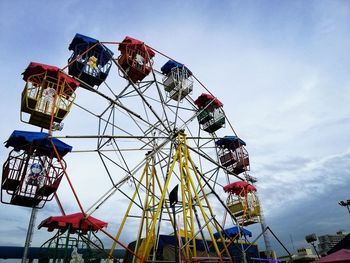 Low angle view of ferris wheel against sky