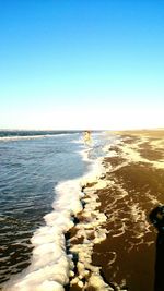 Scenic view of sea against clear blue sky