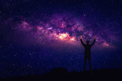 Man standing against star field