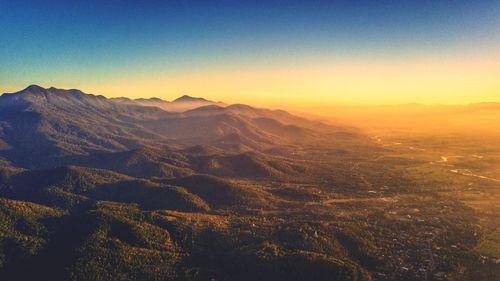 Scenic view of mountains against clear sky during sunset