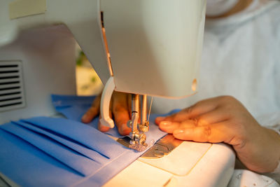 Midsection of man working on table