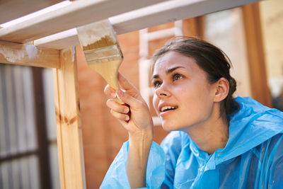 Close-up of young woman holding paintbrush