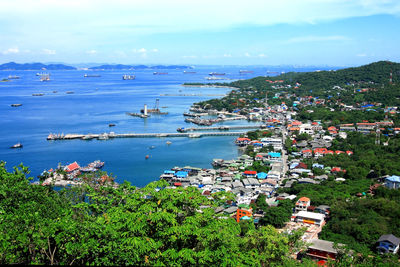 High angle view of townscape by sea against sky