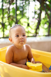 High angle view of cute baby boy in bathtub