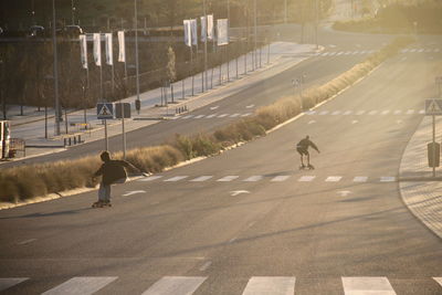 People skating on road