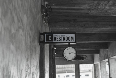 Low angle view of information sign on wall