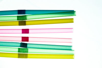 Close-up of multi colored pencils over white background