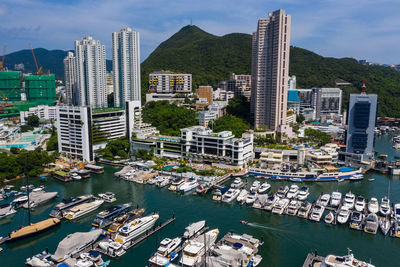 High angle view of harbor by buildings against sky