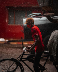 Man with umbrella on street in rain