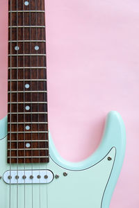 Close-up of guitar against yellow background