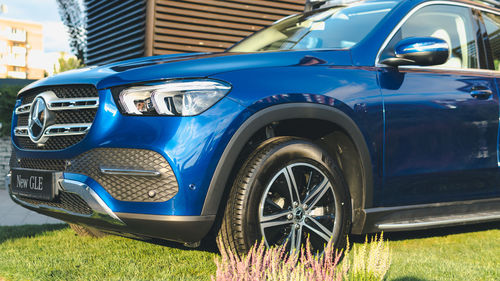 View of blue car parked in city