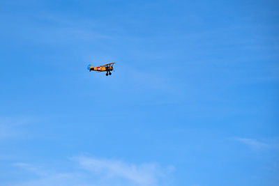 Low angle view of helicopter against sky