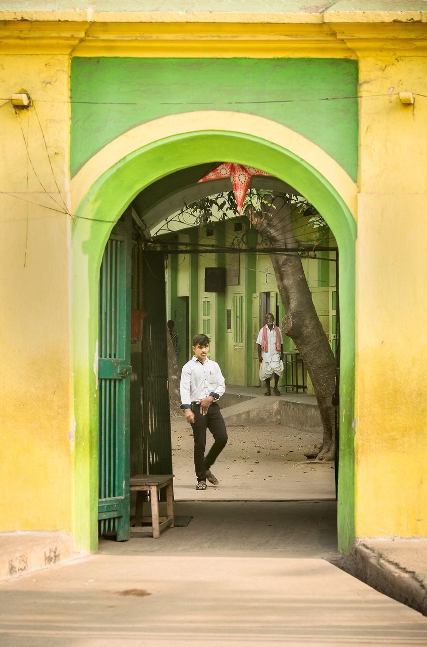 architecture, built structure, building exterior, full length, lifestyles, arch, leisure activity, walking, casual clothing, person, door, men, rear view, entrance, street, boys, house