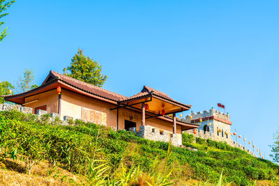 Low angle view of buildings against clear blue sky