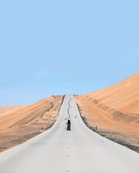 Country road against clear sky