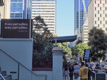 People in city against buildings