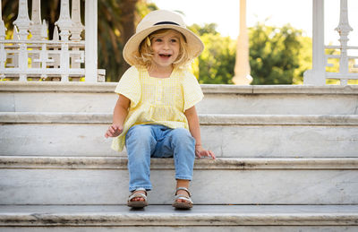 Portrait of baby girl sitting on staircase