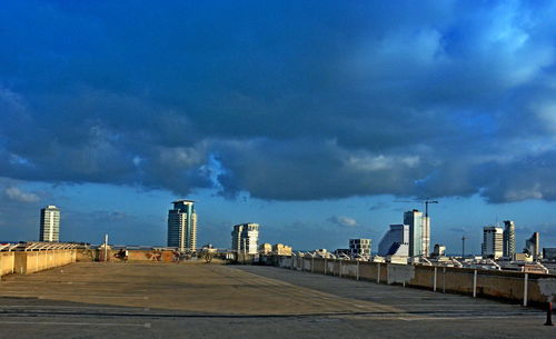 City street by buildings against sky