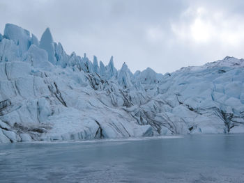 Scenic view of frozen landscape against sky