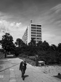 Full length of man walking on road against sky