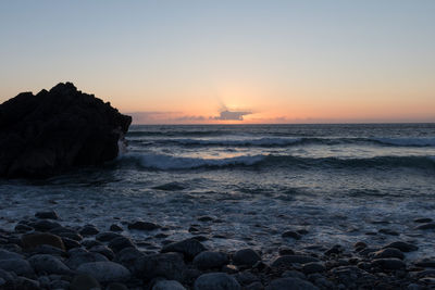 Scenic view of sea against clear sky during sunset