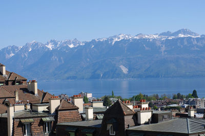 High angle view of houses by sea against clear sky