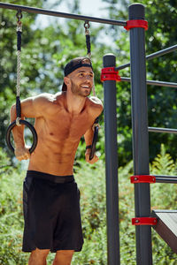 Rear view of man exercising in playground