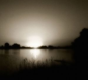 Scenic view of calm lake at sunset