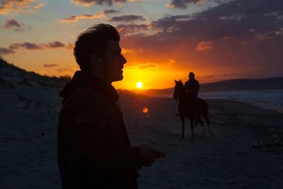 Silhouette of woman at sunset