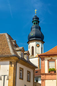 Low angle view of buildings against blue sky