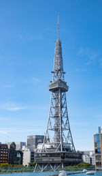 Low angle view of communications tower against sky