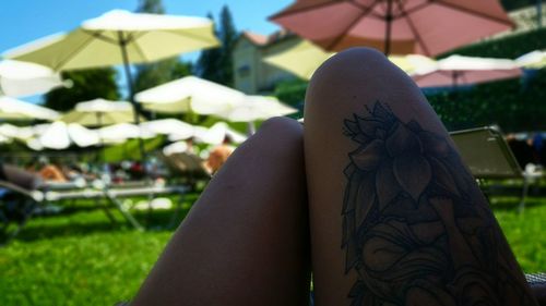 Woman with floral tattoo on lap