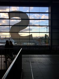 Reflection of people on glass window