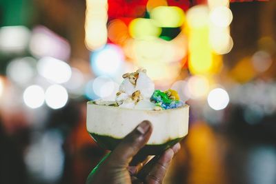 Close-up of hand holding ice cream