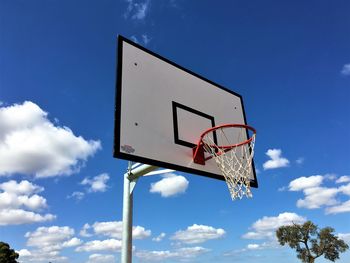 Low angle view of basketball hoop against blue sky