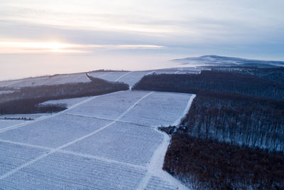 Scenic view of snowy landscape against sky during sunset