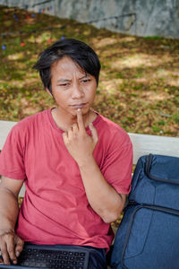 Portrait of boy sitting on chair