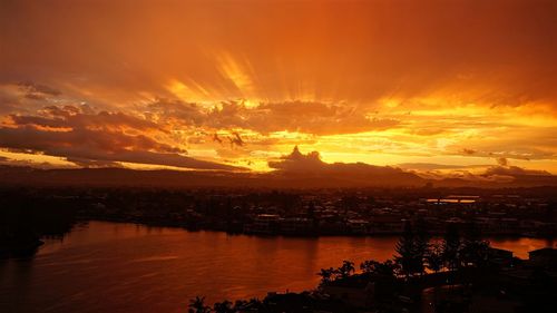 Scenic view of sea against dramatic sky during sunset