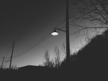 Low angle view of electricity pylon against sky