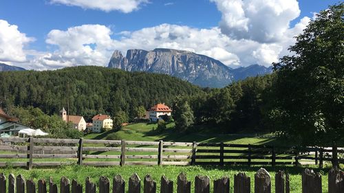 Scenic view of trees and mountains against sky