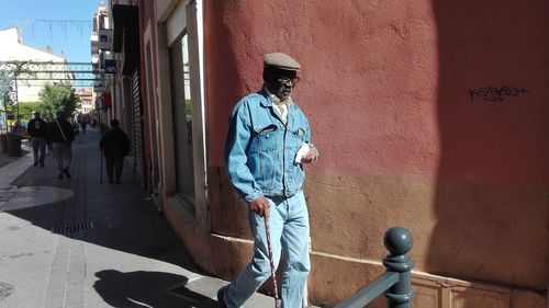 Rear view of man walking on road