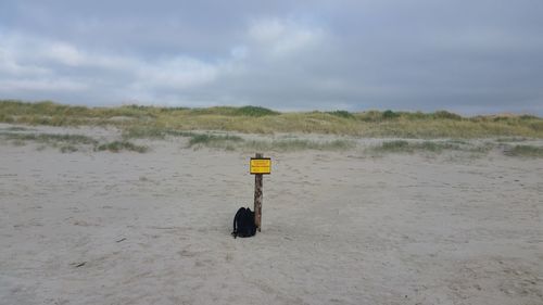 Lifeguard hut on beach against sky