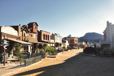 Street amidst buildings in town against sky