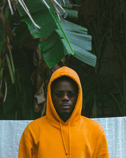 Portrait of young man standing in banana trees garden 