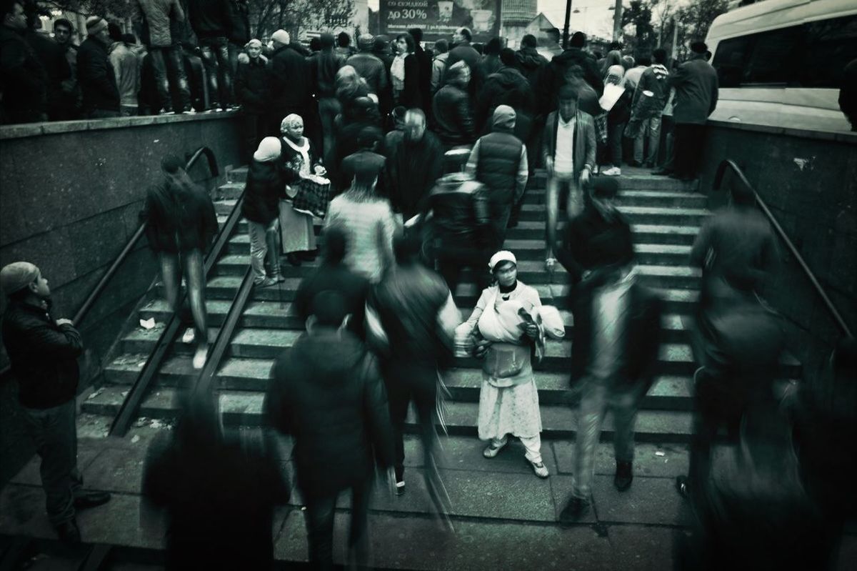 large group of people, men, person, lifestyles, indoors, crowd, walking, leisure activity, mixed age range, medium group of people, city life, group of people, street, high angle view, togetherness, illuminated, blurred motion, night, standing