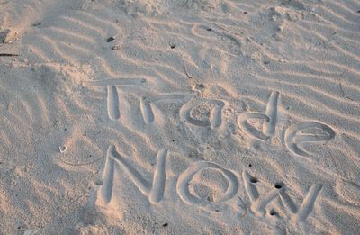 High angle view of text on sand at beach